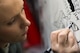 Staff Sgt. Anita, 380th Expeditionary Aircraft Maintenance Squadron U-2 maintainer, traces a mural for a historical U-2 achievement at an undisclosed location in Southwest Asia, Jan. 30, 2017.  (U.S. Air Force photo/Senior Airman Tyler Woodward)