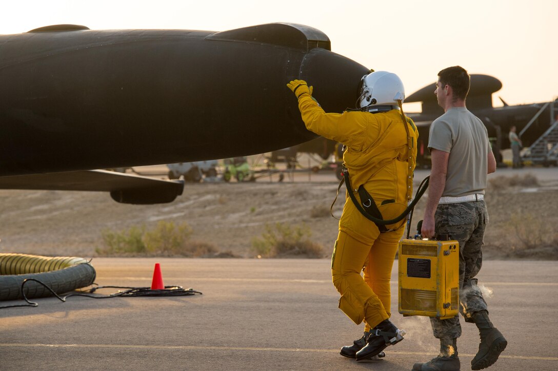 U-2 pilot Maj. Ryan completes a pre-flight tradition of greeting the aircraft before flying a sortie in support of Combined Joint Task Force-Operation Inherent Resolve at an undisclosed location in Southwest Asia, Feb. 2, 2017. During the sortie, the aircraft completed 30,000 hours of flight. This marked the second U-2 in the USAF fleet to reach the milestone and the first overall while flying expeditionary missions under Air Force Central Command. (U.S. Air Force photo/Senior Airman Tyler Woodward)