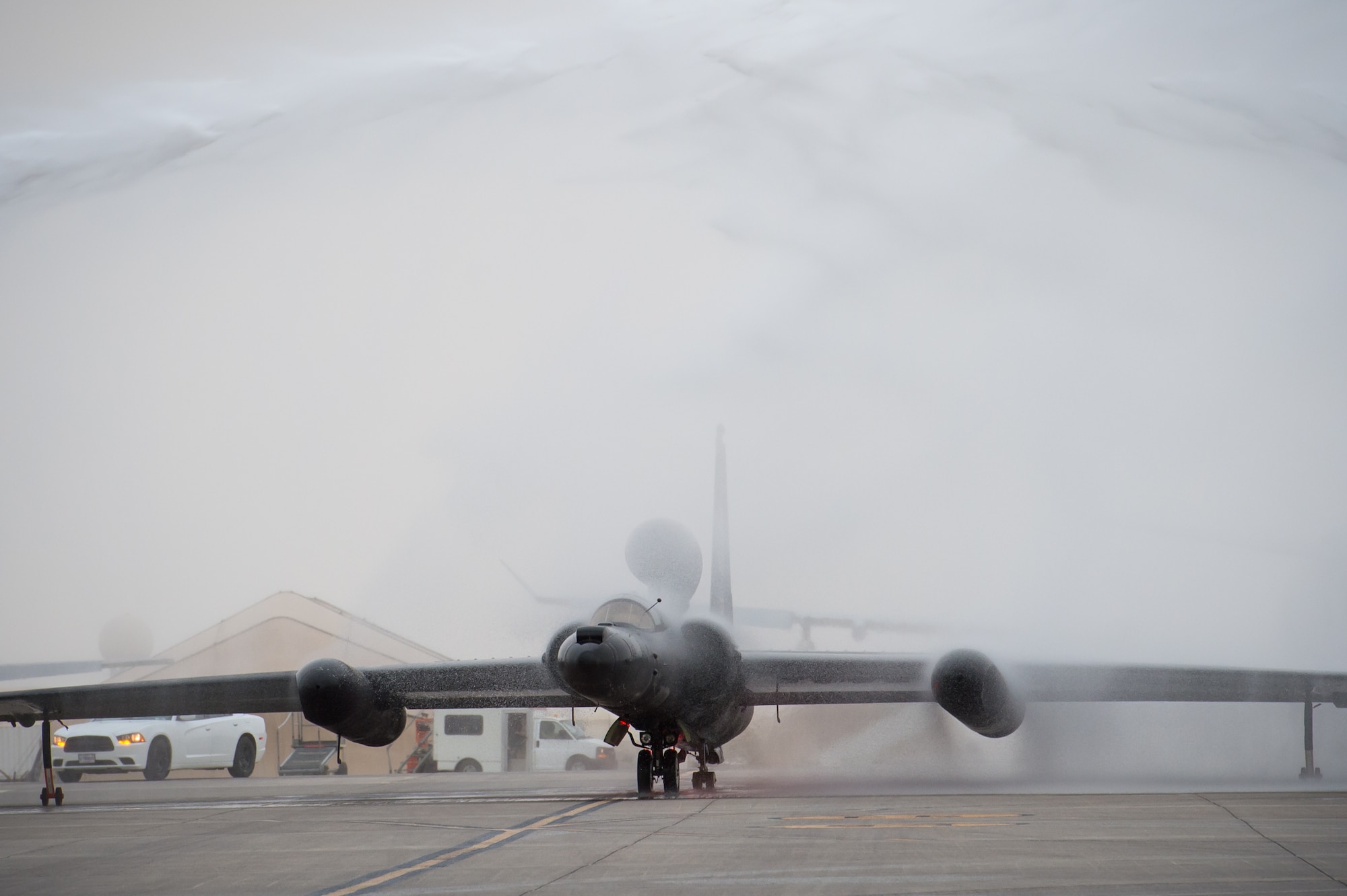 A U-2 taxis through a ceremonial shower after completing 30,000 flight hours at an undisclosed location in Southwest Asia, Feb. 2, 2017. Firetrucks parked on either side of the U-2 and discharged water for the ceremony. The milestone marks the second U-2 in the Air Force fleet to reach the historic milestone. (U.S. Air Force photo/Senior Airman Tyler Woodward)