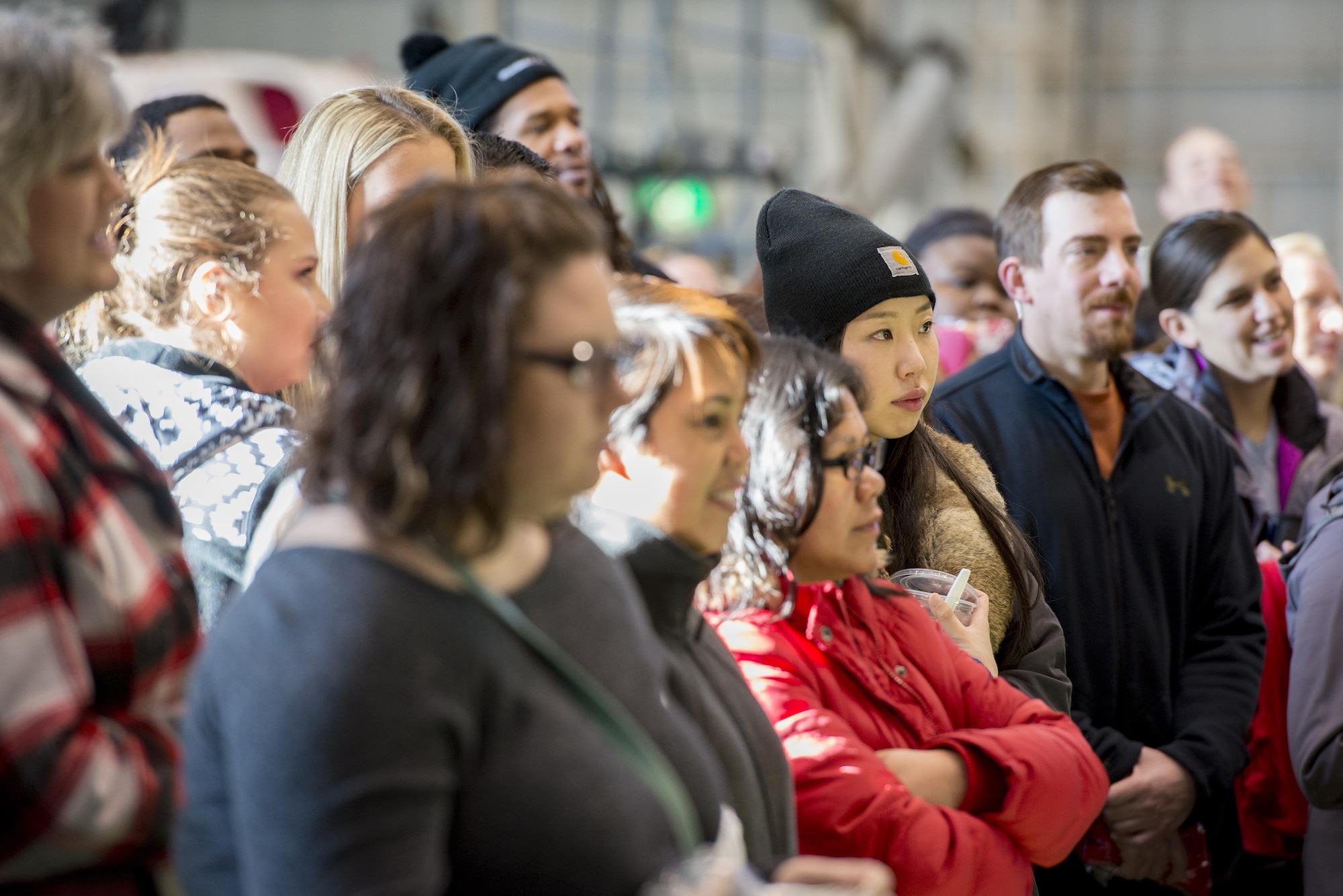 Military spouses listen to a pre-flight briefing during a Spouse Orientation Flight Feb. 1, 2017, at Yokota Air Base, Japan. Approximately 190 spouses participated in the event and were able to fly on three different airframes; C-130H Hercules, C-12 Huron and a UH-1N Iroquois. (U.S. Air Force photo by Airman 1st Class Donald Hudson)