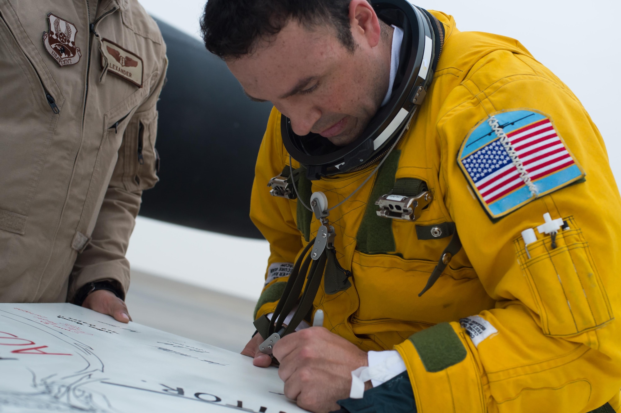 Maj. Ryan, a U-2 pilot, signs a mural created in celebration of a U-2 airframe achieving a 30,000 flight hours at an undisclosed location in Southwest Asia, Feb. 2, 2017. This marked the second U-2 in the USAF fleet to reach the milestone and the first overall while flying expeditionary missions under Air Force Central Command. (U.S. Air Force photo/Senior Airman Tyler Woodward)