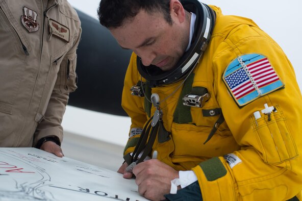 Maj. Ryan, a U-2 pilot, signs a mural created in celebration of a U-2 airframe achieving a 30,000 flight hours at an undisclosed location in Southwest Asia, Feb. 2, 2017. This marked the second U-2 in the USAF fleet to reach the milestone and the first overall while flying expeditionary missions under Air Force Central Command. (U.S. Air Force photo/Senior Airman Tyler Woodward)