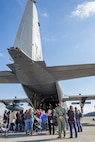 Military spouses listen to a safety briefing before flying on a C-130H Hercules during a Spouse Orientation Flight Feb. 1, 2017, at Yokota Air Base, Japan. Approximately 190 spouses participated in the event and were able to fly on three different airframes; C-130H Hercules, C-12 Huron and a UH-1N Iroquois. (U.S. Air Force photo by Airman 1st Class Donald Hudson)