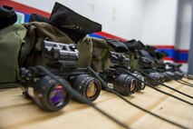 Night vision goggles sit on a table waiting to be used during a Spouse Orientation Flight Feb. 1, 2017, at Yokota Air Base, Japan. The event included a static display of a C-130H Hercules engine, prop and aircraft, a C-12 Huron and a hands on night vision goggle demonstration. (U.S. Air Force photo by Airman 1st Class Donald Hudson)