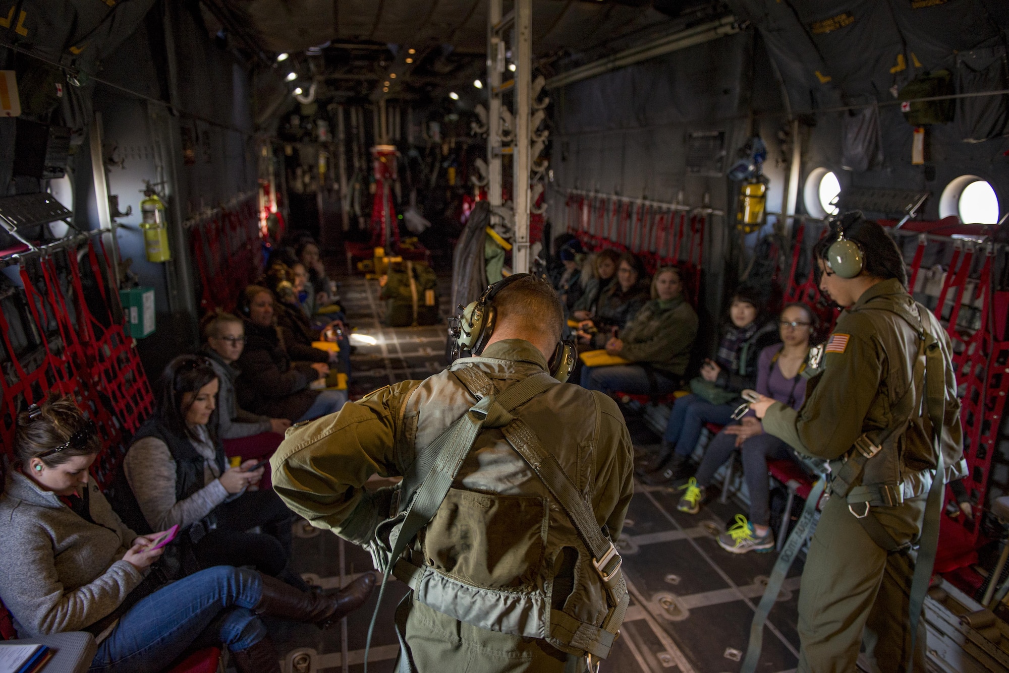 C-130H Hercules loadmasters prepare to open the cargo door of a C-130H as spouses watch during a Spouse Orientation Flight Feb. 1, 2017, at Yokota Air Base, Japan. The event is the last scheduled C-130H Spouse Orientation Flight before the aircraft are retired from active duty. (U.S. Air Force photo by Airman 1st Class Donald Hudson)