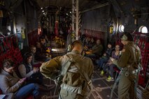 C-130H Hercules loadmasters prepare to open the cargo door of a C-130H as spouses watch during a Spouse Orientation Flight Feb. 1, 2017, at Yokota Air Base, Japan. The event is the last scheduled C-130H Spouse Orientation Flight before the aircraft are retired from active duty. (U.S. Air Force photo by Airman 1st Class Donald Hudson)