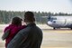 A father and daughter watch mother take off in a C-130H Hercules during a Spouse Orientation Flight Feb. 1, 2017, at Yokota Air Base, Japan. The SOF was to bolster morale, showcase the teamwork between the 374th Operations Group and the 374th Maintenance Group and to ensure families understand their vital contribution to the Air Force mission. (U.S. Air Force photo by Airman 1st Class Donald Hudson)