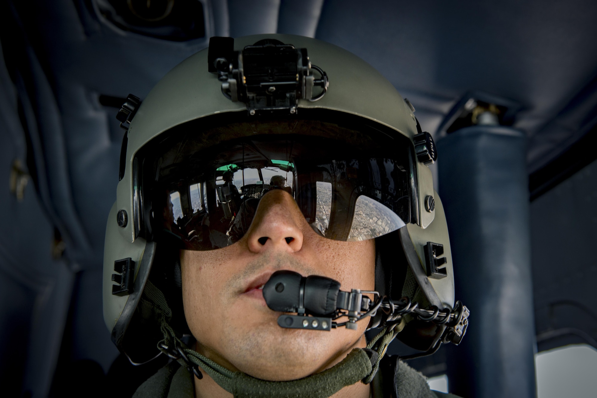 Tech. Sgt. Michael Wright, 459th Airlift Squadron special mission aviator evaluator, looks out window of UH-1N Iroquois during a Spouse Orientation Flight Feb. 1, 2017, near Tokyo, Japan. Participants who flew in a UH-1N were given an aerial tour of down town Tokyo. (U.S. Air Force photo by Airman 1st Class Donald Hudson)