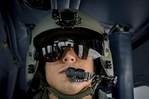 Tech. Sgt. Michael Wright, 459th Airlift Squadron special mission aviator evaluator, looks out window of UH-1N Iroquois during a Spouse Orientation Flight Feb. 1, 2017, near Tokyo, Japan. Participants who flew in a UH-1N were given an aerial tour of down town Tokyo. (U.S. Air Force photo by Airman 1st Class Donald Hudson)