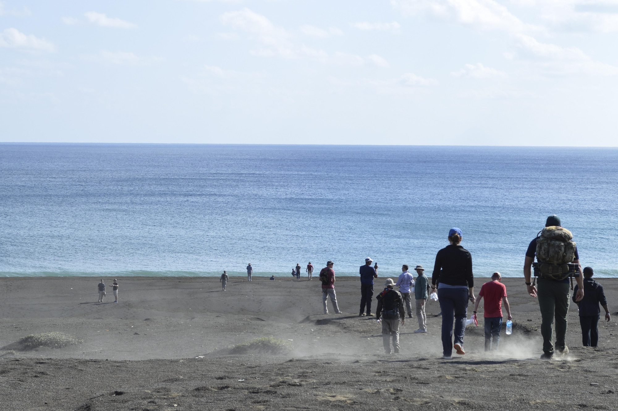 U.S. Air Force Airmen from Kadena Air Base, Japan, walk down a beach slope Jan. 12, 2017, at Iwo Jima. Airmen explored the island as part of a professional military education experience to learn about the history of the island. (U.S. Air Force photo by Senior Airman Lynette M. Rolen/Released)