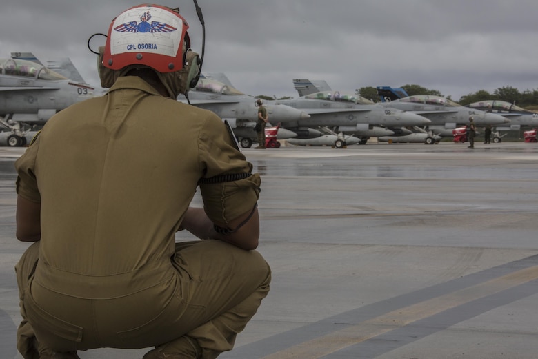 A U.S. Marine with Marine All Weather Fighter Attack Squadron (VMFA) 225 waits to direct F/A-18D Hornets during exercise Cope North at Andersen Air Force Base, Guam, Feb. 3, 2017. Marines trained with the Royal Australian Air Force and Japan Air Self-Defense Force supporting theater security, focusing on dissimilar air combat training and large force employment. (U.S. Marine Corps photo by Cpl. Nathan Wicks)