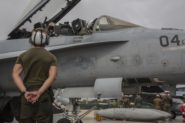 A U.S. Marine and pilots with Marine All Weather Fighter Attack Squadron (VMFA) 225 finish their final inspection of an F/A-18D Hornet before it takes off during exercise Cope North at Andersen Air Force Base, Guam, Feb. 3, 2017. Marines trained with the Royal Australian Air Force and Japan Air Self-Defense Force supporting theater security, focusing on dissimilar air combat training and large force employment. (U.S. Marine Corps photo by Cpl. Nathan Wicks)