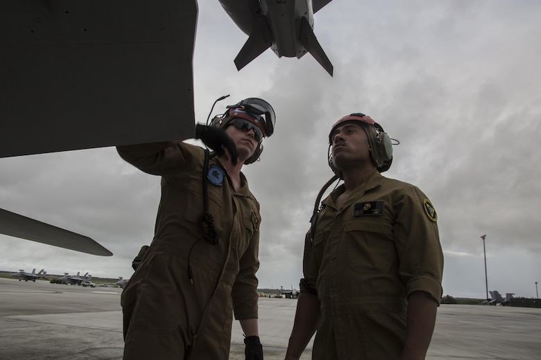 U.S. Marine Corps Sgt. Christopher Edwards, left, and U.S. Marine Corps Cpl. Angel Osoria, aviation ordnance Marines with Marine All Weather Fighter Attack Squadron (VMFA) 225, inspect an F/A-18D Hornet during exercise Cope North 17 at Andersen Air Force Base, Guam, Feb. 3, 2017. The Marines inspect the aircraft prior to take off to ensure it is fit for flight. Marines trained with the Royal Australian Air Force and Japan Air Self-Defense Force supporting theater security, focusing on dissimilar air combat training and large force employment. (U.S. Marine Corps photo by Cpl. Nathan Wicks)