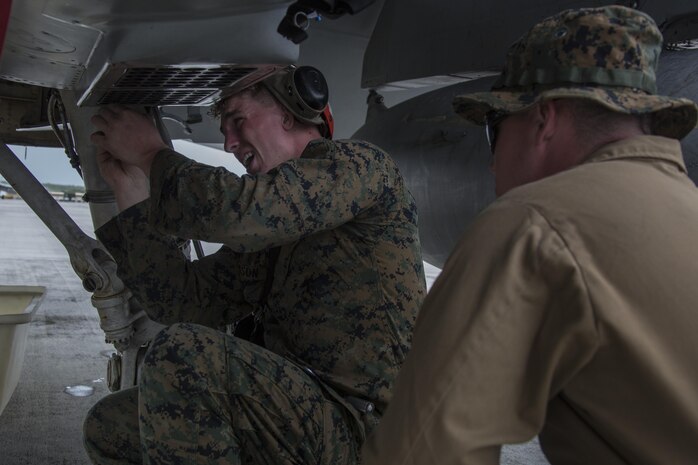 U.S. Marines with Marine All Weather Fighter Attack Squadron 225 (VMFA) inspect an F/A-18D Hornet during exercise Cope North at Andersen Air Force Base, Guam, Feb. 3, 2017. The Marines inspect the aircraft prior to take off to ensure it is fit for flight. Marines trained with the Royal Australian Air Force and Japan Air Self-Defense Force supporting theater security, focusing on dissimilar air combat training and large force employment. (U.S. Marine Corps photo by Cpl. Nathan Wicks)