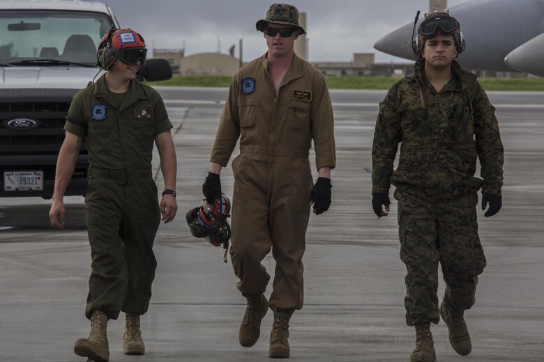 From left to right, U.S. Marine Corps Sgt. Matthew Dailey, Sgt. Christopher Edwards and Cpl. Joel Pozosrodriguez, aviation ordnance Marines with Marine All Weather Fighter Attack Squadron (VMFA) 225 walk down the flight line as they inspect F/A-18D Hornets preparing to take off during exercise Cope North 17 at Andersen Air Force Base, Guam, Feb. 3, 2017. Marines trained with the Royal Australian Air Force and Japan Air Self-Defense Force supporting theater security, focusing on dissimilar air combat training and large force employment. (U.S. Marine Corps photo by Cpl. Nathan Wicks)