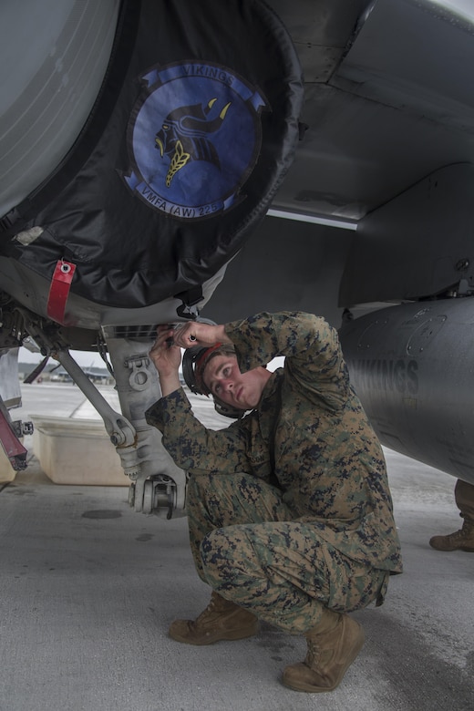 A U.S. Marine with Marine All Weather Fighter Attack Squadron (VMFA) 225 inspects an F/A-18D Hornet during exercise Cope North at Andersen Air Force Base, Guam, Feb. 3, 2017. The Marines inspect the aircraft prior to take off to ensure it is fit for flight. Marines trained with the Royal Australian Air Force and Japan Air Self-Defense Force supporting theater security, focusing on dissimilar air combat training and large force employment. (U.S. Marine Corps photo by Cpl. Nathan Wicks)