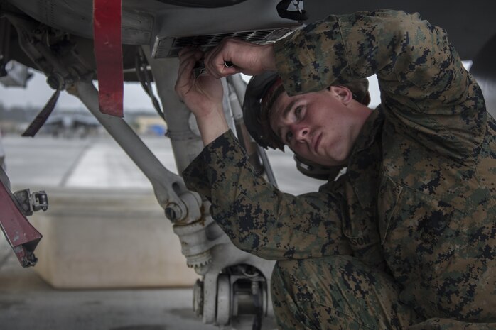 A U.S. Marine with Marine All Weather Fighter Attack Squadron (VMFA) 225 inspects an F/A-18D Hornet during exercise Cope North at Andersen Air Force Base, Guam, Feb. 3, 2017. The Marines inspect the aircraft prior to take off to ensure it is fit for flight. Marines trained with the Royal Australian Air Force and Japan Air Self-Defense Force supporting theater security, focusing on dissimilar air combat training and large force employment. (U.S. Marine Corps photo by Cpl. Nathan Wicks)