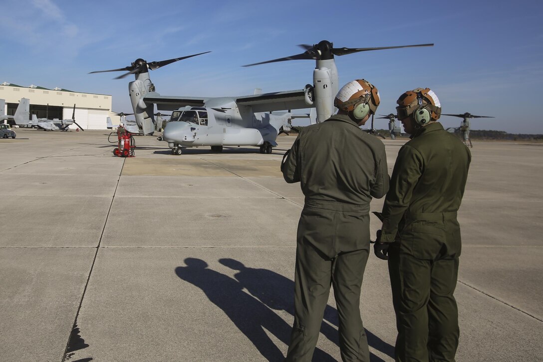 MARINE CORPS AIR STATION NEW RIVER, N.C.—Lance Cpl. Luke Peters and his fellow Marine discuss an MV-22B Block C Osprey after it landed aboard MCAS New River, N.C., Feb. 1, 2017. This is the first time the training squadron has received a brand-new, straight from the factory aircraft. The MV-22B Block C incorporates weather radar; an improved environmental control system; troop commander situational awareness display; upgraded standby flight instrument and GPS; and additional chaff/flare equipment.  Block C development first began in 2006. Peters is a crew chief with Marine Medium Tiltrotor Training Squadron 204 . (U.S. Marine Corps photo by Lance Cpl. Miranda Faughn/Released)
