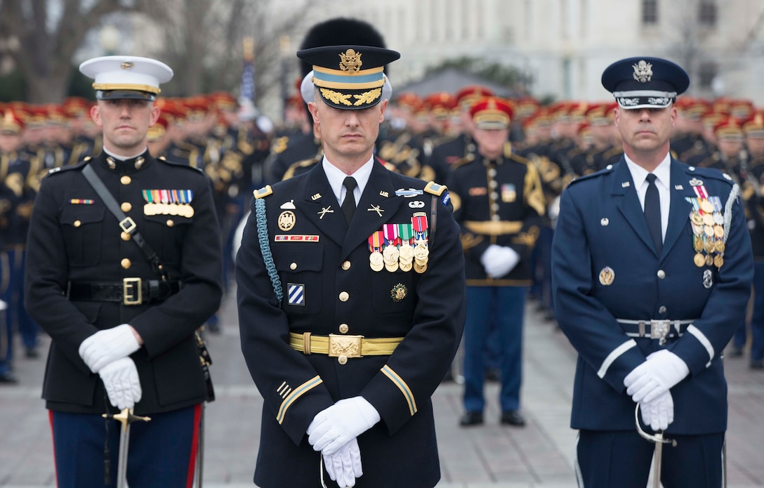 U.S. Military Service members participating in the Presidential Escort stand at parade rest at the U.S. Capitol during the 58th Presidential Inauguration in Washington D.C., Jan. 20, 2017. More than 5,000 military members from across all branches of the armed forces of the United States, including Reserve and National Guard components, provided ceremonial support and Defense Support of Civil Authorities during the inaugural period. (DOD photo by U.S. Army Spc. William Lockwood)