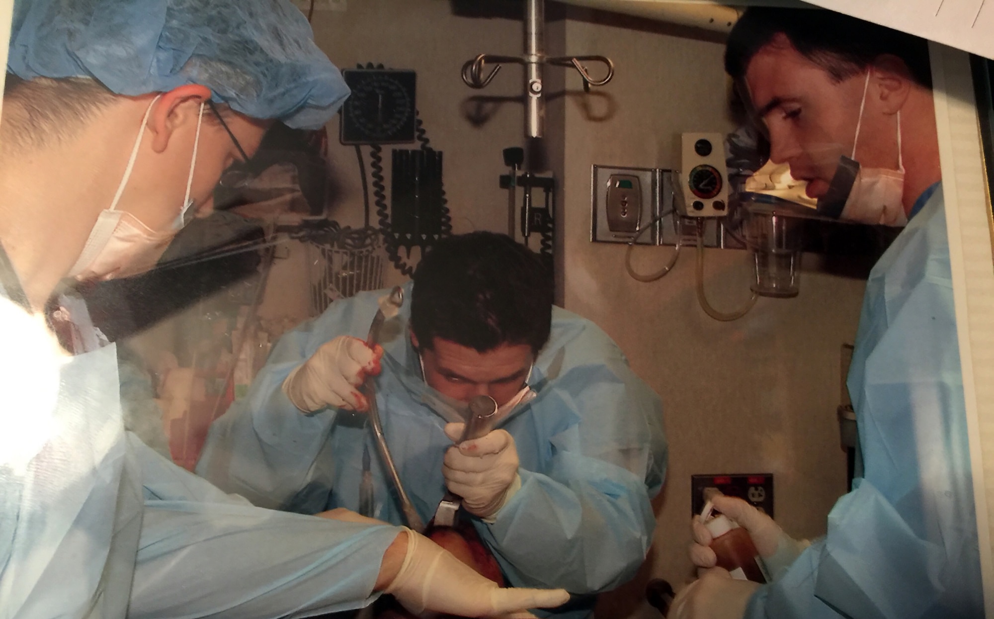 (left) Maj. Michael Policastro, 445th Aeromedical Staging Squadron officer in-charge of Critical Care Air Transport, helps perform a medical procedure as an emergency medicine physician and toxicologist in his civilian job in Cincinnati, Ohio. For the third year in a row, Cincinnati Magazine named Major Policastro as one of the top emergency medicine physicians in Cincinnati. (Courtesy photo) 