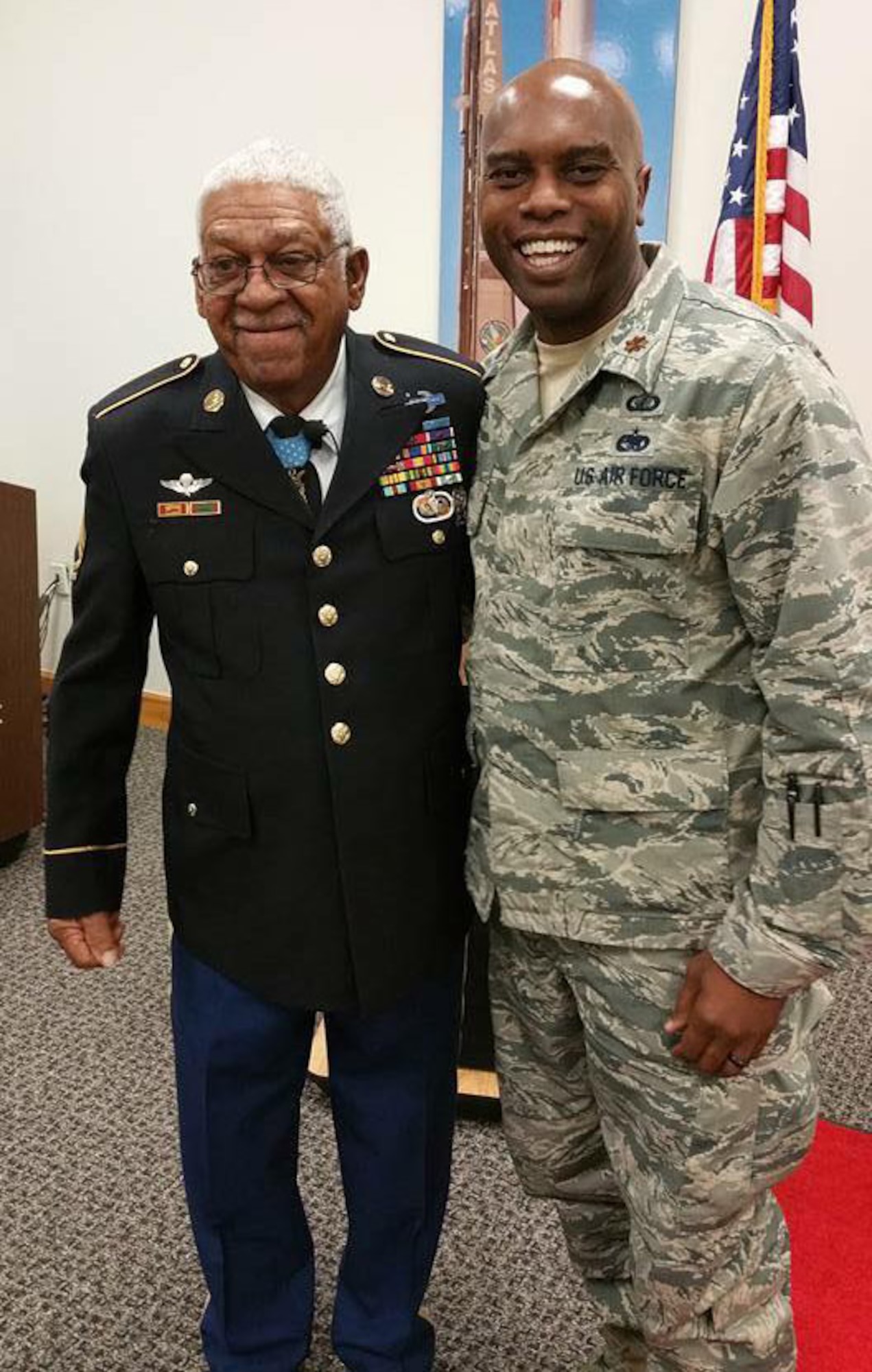 Medal of Honor recipient retired U.S. Army Sgt. 1st Class Melvin Morris coined Maj. Marcus Smith, 308th Rescue Squadron, Patrick Air Force Base, Fla., Jan. 31, 2017. During a visit to PAFB, Morris gave a presentation emphasizing the importance of pushing through adversity because "we are trained and trusted to always get the job done regardless of our circumstances." (Courtesy photo)
