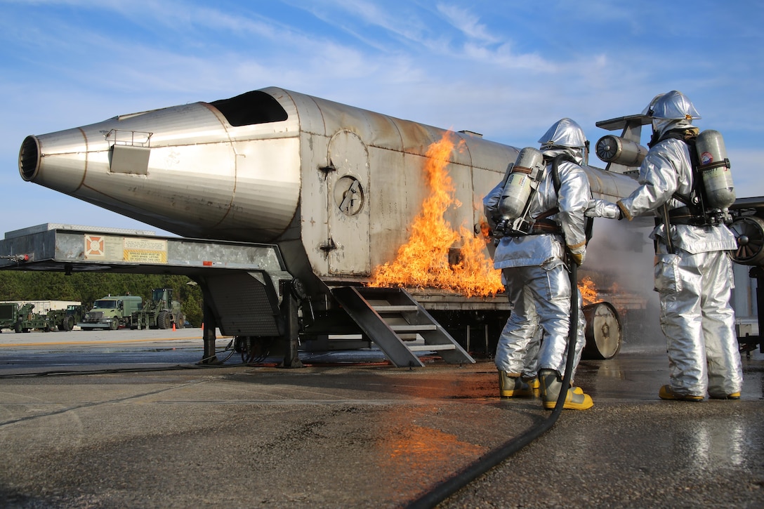 Aircraft rescue and firefighting Marines with Marine Wing Support Squadron 271, Marine Aircraft Group 14, 2nd Marine Aircraft Wing, extinguish a training fire aboard Marine Corps Auxiliary Landing Field Bogue, N.C., Feb. 1, 2017. The training was conducted using a Mobile Aircraft Firefighting Training Device, which is a propane powered, controlled system used to simulate an aircraft fire. AARF Marines must conduct the training regularly in order to remain proficient. (U.S. Marine Corps photo by Cpl. Mackenzie Gibson/Released)
