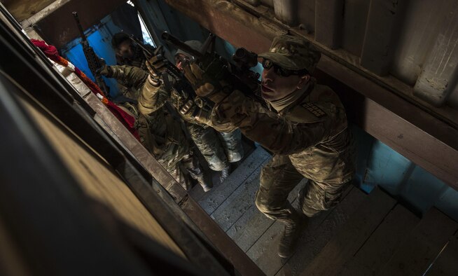 Combat camera Airmen clear a stairwell during close-quarters battle training at McCrady Training Center, Eastover, S.C., Jan. 27, 2017. Exercise Scorpion Lens is an annual ‘ability to survive and operate’ training exercise mandated by Air Force Combat Camera job qualification standards. The exercise’s purpose is to provide refresher training to combat camera personnel in the areas of combat tactics, photography, videography and on procedures inherent to support combat camera mission tasks. (U.S. Air Force photo/Airman 1st Class James R. Crow)