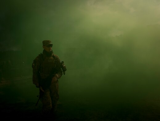 U. S. Air Force Staff Sgt. Nicholas Priest, 1st Combat Camera Squadron combat broadcast journalist, uses a smoke grenade as coverage for crossing an intersection during close quarters battle training at McCrady Training Center, Eastover, S. C., Jan. 27, 2017. Exercise Scorpion Lens is an annual Ability To Survive and Operate training exercise mandated by Air Force Combat Camera job qualification standards. Held at the United States Army Training Center Fort Jackson, S. C., and the McCrady Training Center, Eastover, S.C. the exercise’s purpose is to provide refresher training to combat camera personnel. Individuals are instructed in the areas of combat tactics, photography, videography and on procedures inherent to support combat camera mission tasks. (U.S. Air Force photo by Airman 1st Class James R. Crow)