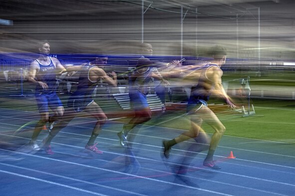 Two Air Force teams hand off their batons during the mile relay at the 27th annual Air Force Invitational at the U.S. Air Force Academy's Cadet Field House in Colorado Springs, Colo., Jan. 21, 2017. The Falcons fielded five teams, grabbing the top two positions, with the Colorado Buffs finishing in third place. (U.S. Air Force photo/ Bill Evans)