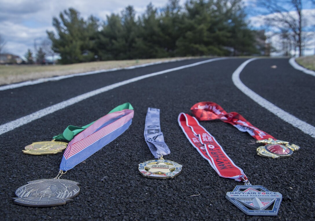Medals awarded to Senior Airman Joshua D. Smith, 811th Security Forces Squadron executive aircraft security team member, lie on a track at Joint Base Andrews, Md., Jan. 27, 2017. The medals represent Smith’s participation in Department of Defense-sponsored running events like the JBA Half Marathon, Navy-Air Force Half Marathon and Marine Corps Marathon. Smith’s most coveted medal is the Ultimate Warrior Medal, an award given to individuals who compete in at least five of these DOD-sponsored events. (U.S. Air Force photo by Senior Airman Jordyn Fetter)