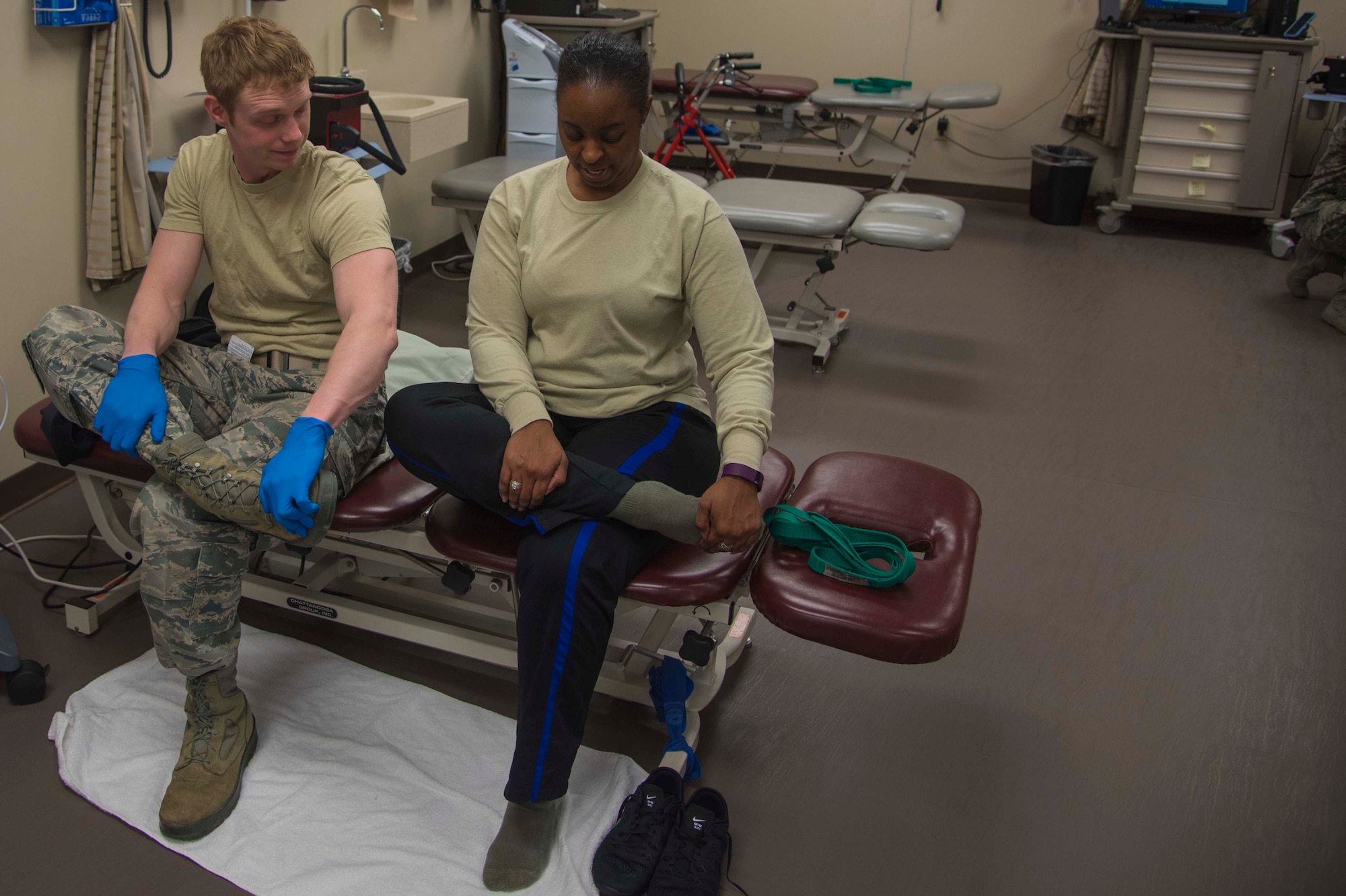 Staff Sgt. Kivynn Pabst, left, 779th Medical Group physical medicine technician, performs a stretch with Master Sgt. Christina Chislom, right, Malcolm Grow Medical Center patient, during a physical therapy appointment at Joint Base Andrews, Md., Feb. 2, 2017. Pabst gives Chislom treatment based on her unique needs.  (U.S. Air Force photo by Airman 1st Class Valentina Lopez)