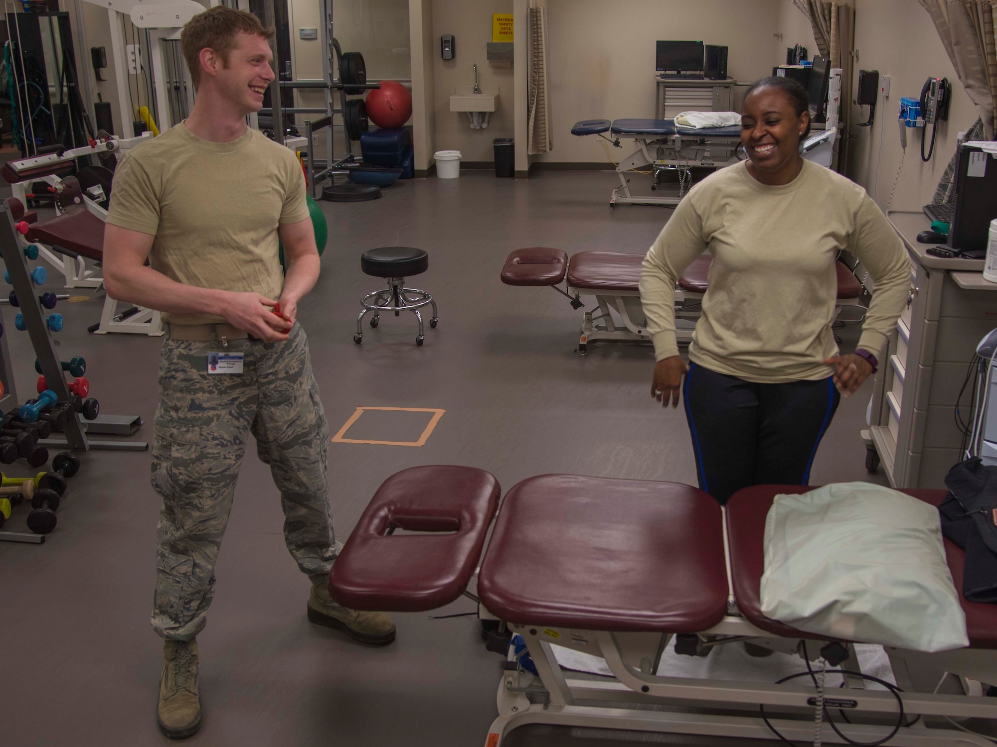Staff Sgt. Kivynn Pabst, left, 779th Medical Group physical medicine technician, talks with Master Sgt. Christina Chislom, Malcolm Grow Medical Center patient, as they move onto the next exercise during a physical therapy appointment at Joint Base Andrews, Md., Feb. 2, 2017. Technicians build a bond of trust with their patients to help them on the road of recovery. (U.S. Air Force photo by Airman 1st Class Valentina Lopez)