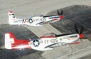Two P-51 Mustangs shimmer against the parking ramp over Davis-Monthan AFB, AZ while practicing formation flying during a USAF Heritage Conference 2002 training flight. The USAF Heritage conference brings together civilian Heritage pilots and USAF Demonstration Team pilots to discuss safety and practice formation flying in a non-airshow environment.  The USAF heritage aircraft and modern day fighters routinely team together to perform at airshows in the &quot;Heritage Flight&quot; formation but must be certified to fly together before the airshow season begins each year.  USAF  Photo by SSgt. Greg L. Davis.