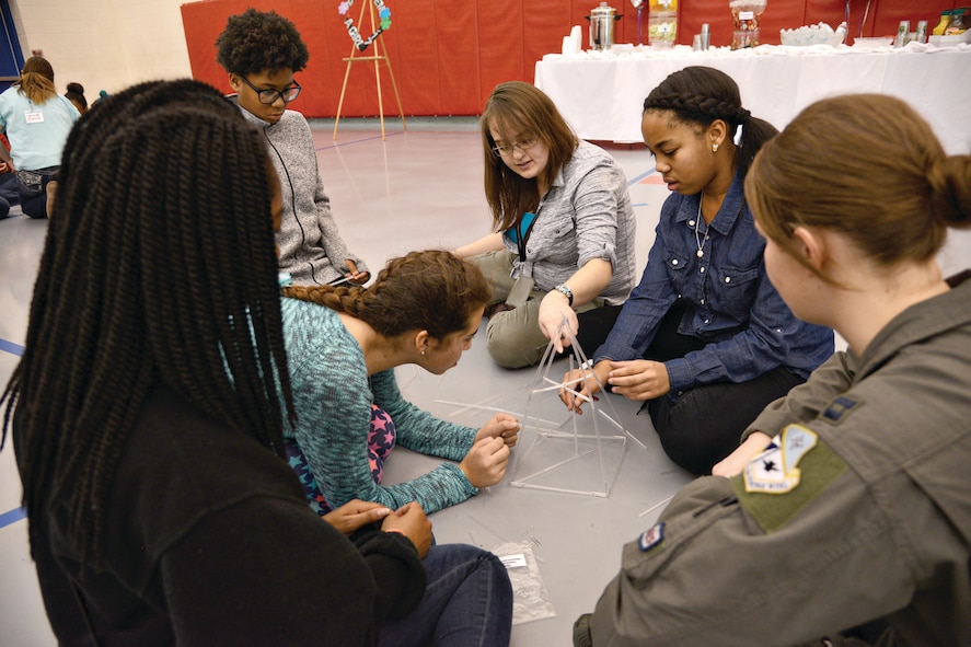 Students and mentors work together in a team building activity to build a straw tower to see how much weight it can support as part of STEM Girls Camp, “STEM Like a Girl” activities. Forty middle school girls attended the camp held on base. (Air Force photo by Kelly White)