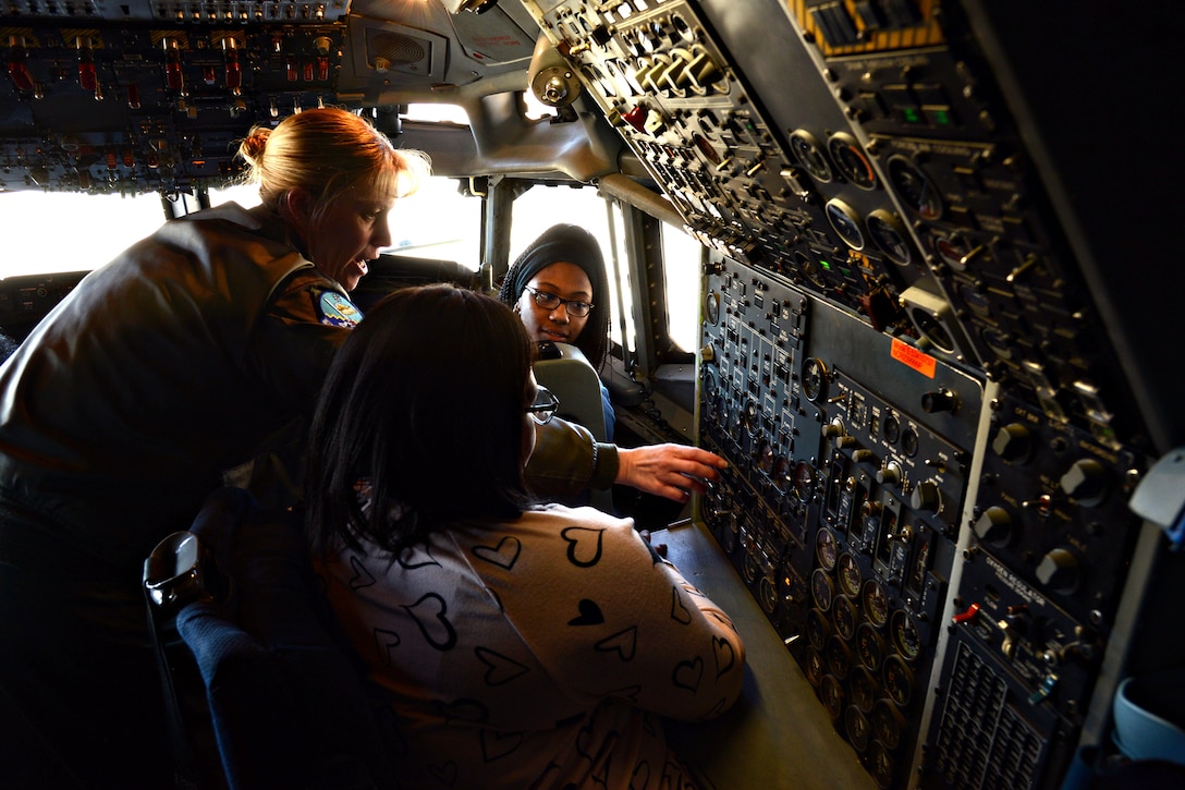 Lt. Col. Kristen Thompson, Commander, 960th Airborne Air Control Squadron, explains some of the gauges on the flight deck of an E-3 Sentry aircraft to two girls attending the first STEM Girls Camp, “STEM Like a Girl” held at Tinker, Jan. 28. (Air Force photo by Kelly White)