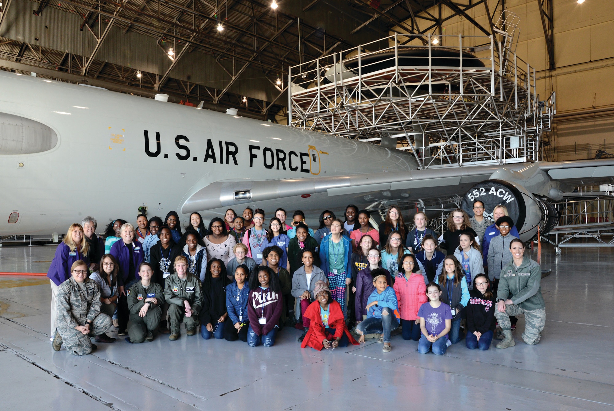 Forty 6th, 7th and 8th grade students, along with their mentors pose for a group photo following their tour of an E-3 Sentry aircraft. The students attended the first STEM Girls Camp, “STEM Like a Girl” held at the base Jan. 28. (Air Force photo by Kelly White)