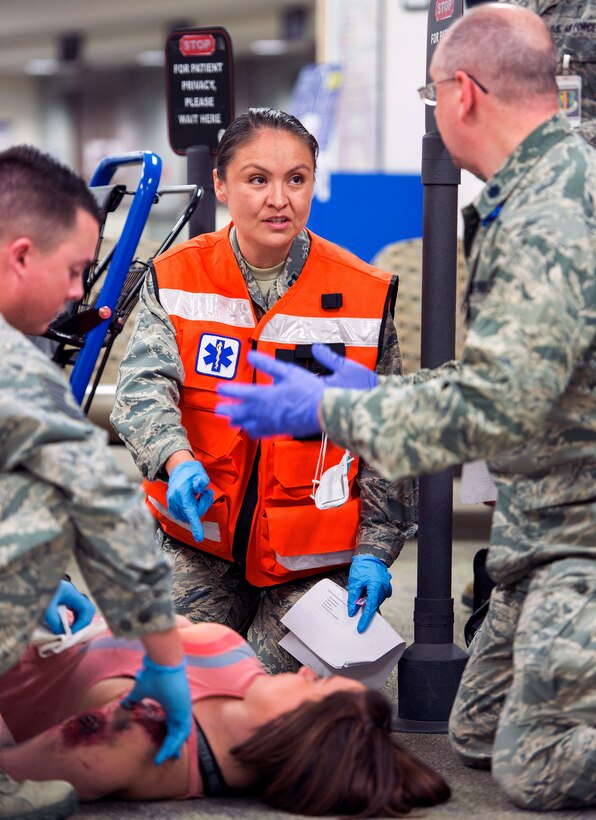 Airmen discuss a medical procedure for a mock patient during an active shooter exercise inside David Grant Medical Center at Travis Air Force Base, Calif., Jan. 26, 2017. Air Force photo by Louis Briscese