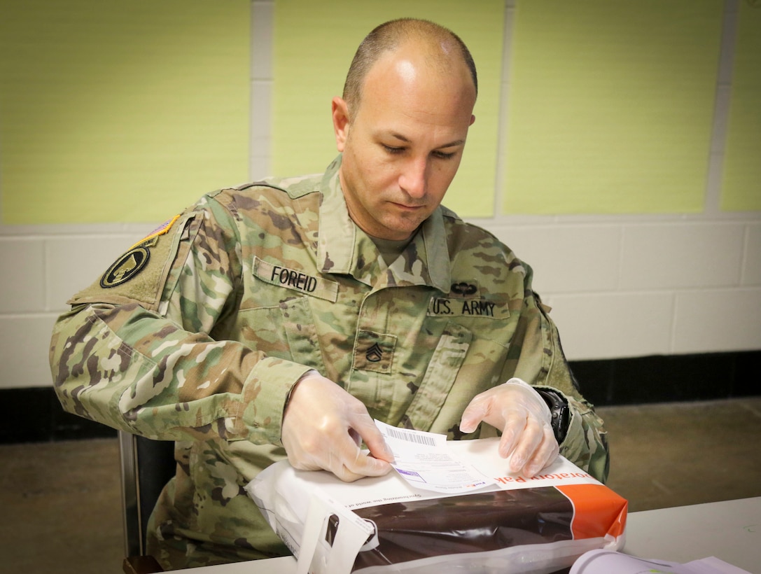 Staff Sgt. Jason Foreid, a radio operator maintainer from Tampa, Florida, assigned to the Joint Communications Support Element, 335th Signal Command (Theater) places a mailing label on an envelope in order to practice proper mailing procedures during a Unit Prevention Leader Course being taught at the 335th SC (T) Headquarters in East Point, Georgia Feb. 2. 