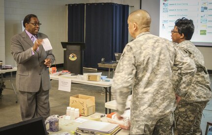 Mr. Eric L. Powell, alcohol and drug control officer for the 335th Signal Command (Theater) gives instruction to Soldiers on how to fill out a mailing label for proper mailing procedures during a Unit Prevention Leader Course being taught at the 335th SC (T) Headquarters in East Point, Georgia Feb. 2.  