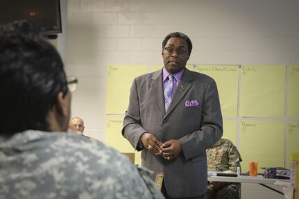 Mr. Eric L. Powell, alcohol and drug control officer for the 335th Signal Command (Theater) answers questions from Sgt. 1st Class Lashara Simmons, a human resources noncommissioned officer and native of Newbern, North Carolina, assigned to the Joint Enabling Capabilities Command, 335th SC (T) during a Unit Prevention Leader Course being taught at the 335th SC (T) Headquarters in East Point, Georgia Feb. 2.  