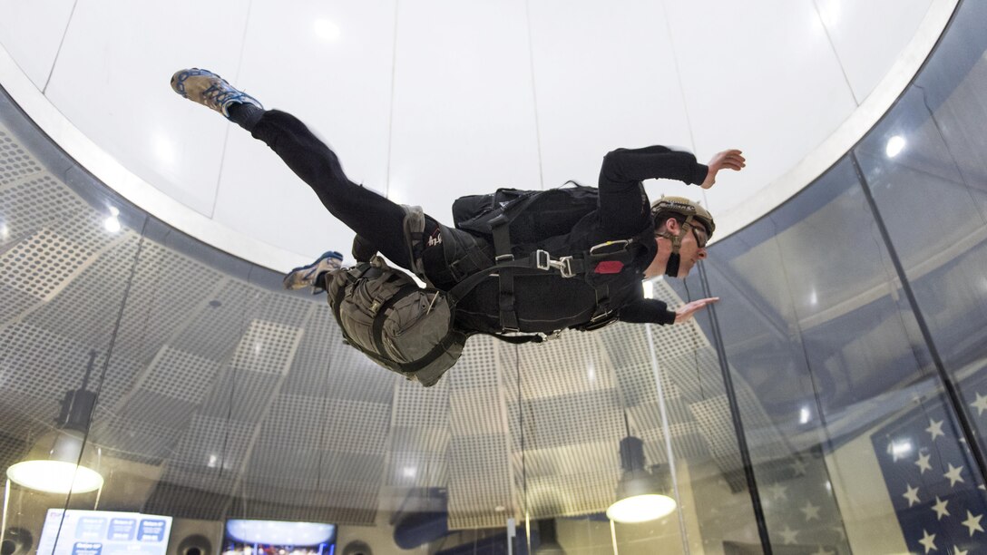 A sailor practices proper free fall technique during military training at a vertical wind tunnel facility in Virginia Beach, Va., Feb. 1, 2017. The sailor is assigned to Explosive Ordnance Disposal Group  2, which oversees all other similar units on the East Coast. Navy photo by Petty Officer 2nd Class Charles Oki