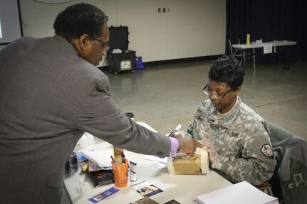 Mr. Eric L. Powell (left), Alcohol and Drug Control Officer for the 335th Signal Command (Theater) gives insruction to Sgt. 1st Class Lashara Simmons, a human resources noncommissioned officer and native of Newbern, North Carolina, currently assigned to the Joint Enabling Capabilities Command, 335th SC (T), on how to apply tape to seal a box for proper mailing procedures during a Unit Prevention Leader Course being taught at the 335th SC (T) Headquarters in East Point, Georgia Feb. 2.  (Official U.S. Army Reserve photo by Sgt. 1st Class Brent C. Powell)