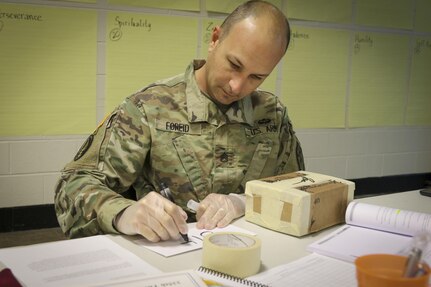 Staff Sgt. Jason Foreid, a radio operator maintainer from Tampa, Florida, assigned to the Joint Communications Support Element, 335th Signal Command (Theater) writes numbers on an envelope in order to practice proper mailing procedures during a Unit Prevention Leader Course being taught at the 335th SC (T) Headquarters in East Point, Georgia Feb. 2. 