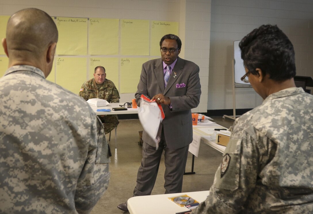 Mr. Eric L. Powell, alcohol and drug control officer for the 335th Signal Command (Theater) gives instruction to Soldiers on how to place a box into a mailing envelope for proper mailing procedures during a Unit Prevention Leader Course being taught at the 335th SC (T) Headquarters in East Point, Georgia Feb. 2.  