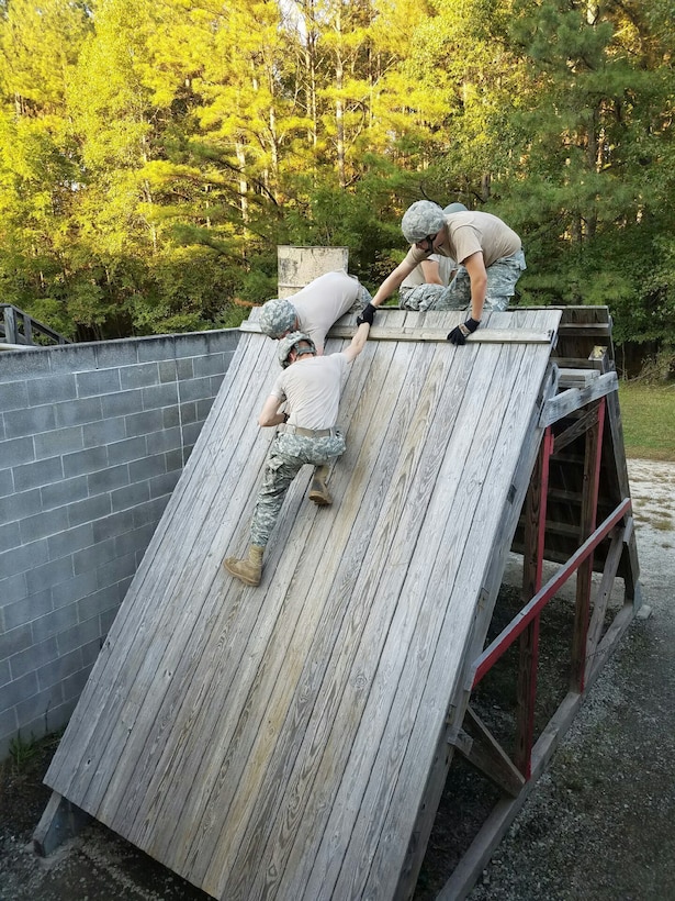 Army Reserve Soldiers from the 261st Ordnance Company, 321st Ordnance Battalion, 38th Regional Support Group, 310th Sustainment Command (Expeditionary), work together to overcome the twenty foot wall obstacle while navigating the Ft. Hood, Texas Leadership Reaction Course (LRC), Jan. 20, 2017. The LRC is comprised of individual obstacles designed to test and strengthen leadership and teamwork skills, while using objects that may or may not be utilized to assist in accomplishing the tasks. 