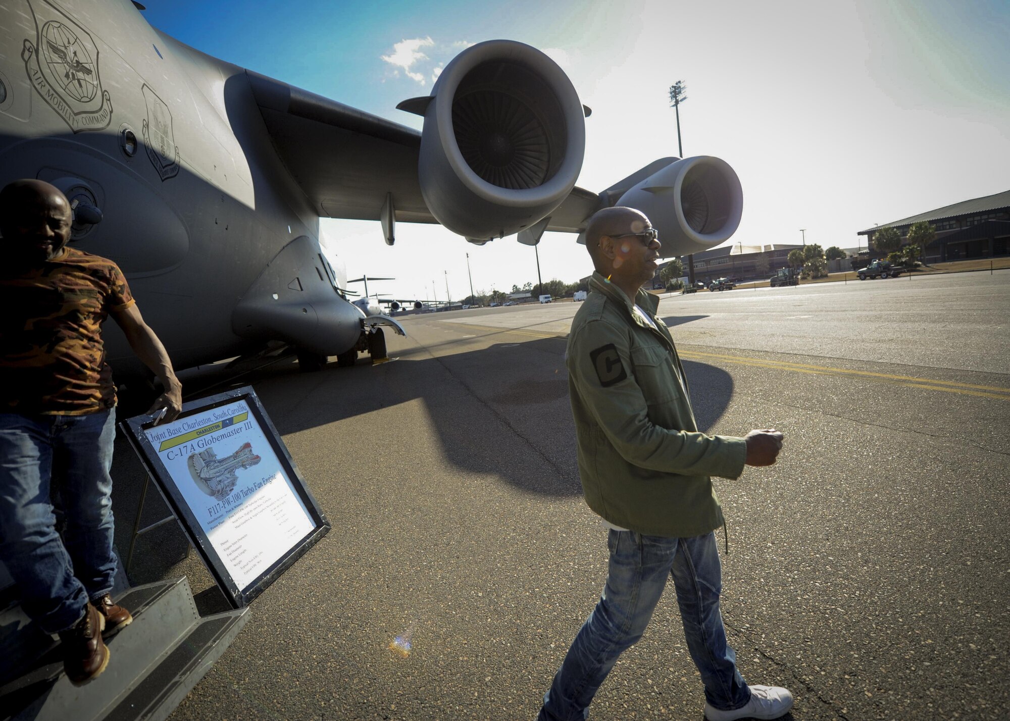 (From right) Actor/comedian Dave Chappelle, and actor/comedian Donnell Rawlings exit a C-17 Globemaster III static display during a visit to the troops at Joint Base Charleston Feb. 2 . Chappelle & Rawlings were in town as part of their comedy tour.  After touring a C-17, the two were welcomed by an eager crowd of over 200 military members and federal civilians at the Charleston Club.  (U.S. Air Force photo by Senior Airman Tom Brading)