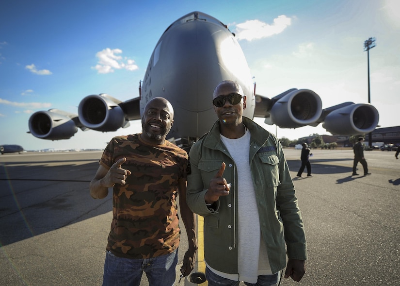 (from right) Actor/comedians Dave Chappelle and  Donnell Rawlings pose for a photo in front of a Joint Base Charleston C-17 Globemaster III Feb. 2.  Chappelle was in town for his stand-up comedy show when he made the visit to see service members and federal civilians at the base. (U.S. Air Force photo by Senior Airman Tom Brading)