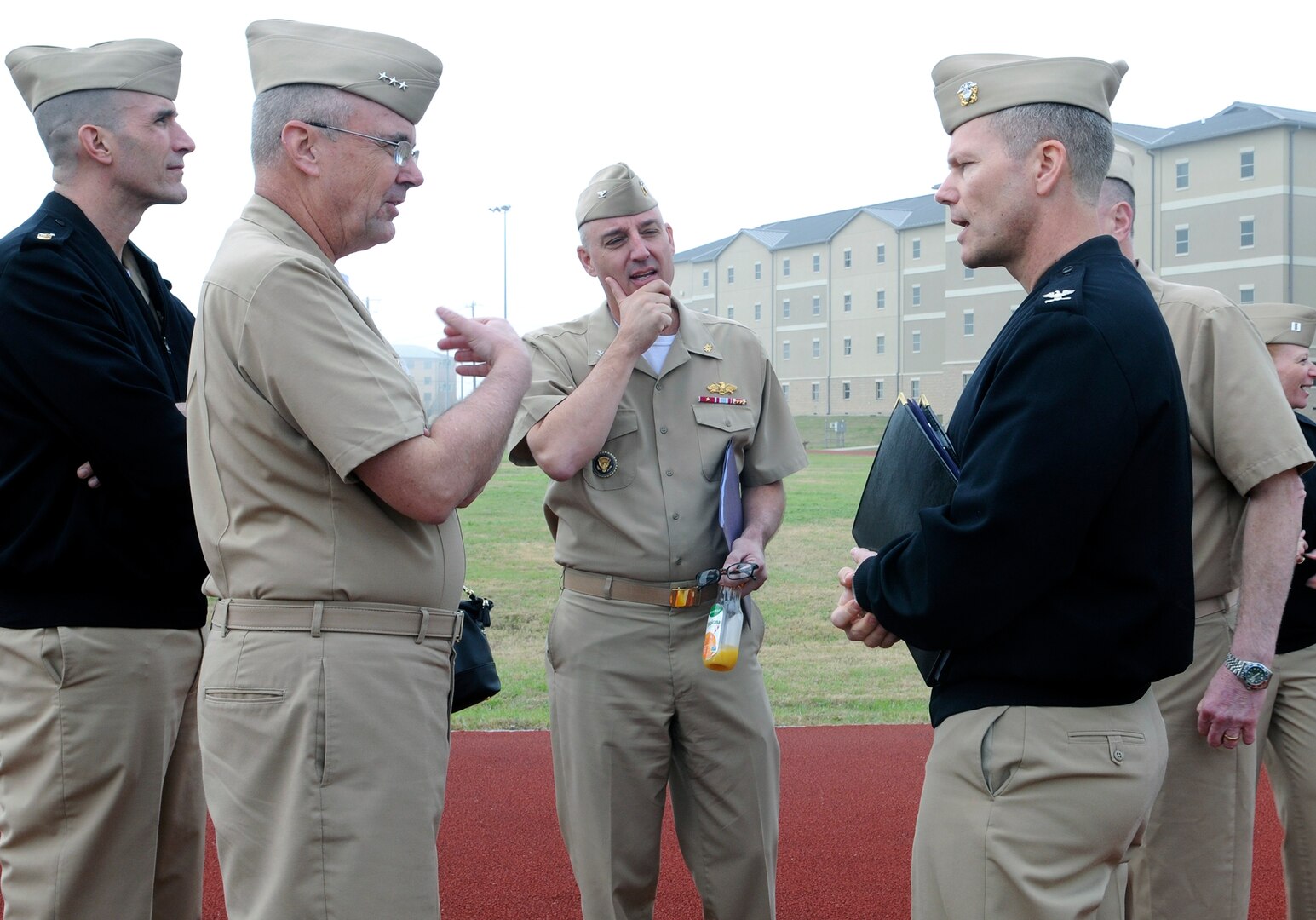 Vice Adm. C. Forrest Faison III, second from left, Navy surgeon general, talks to Capt. Brent Kelln, right, commanding officer, Navy Medicine Training Support Center (NMTSC), at the Medical Education and Training Campus on board Joint Base San Antonio - Fort Sam Houston. Faison visited with NMTSC and their senior command, Navy Medicine Education, Training and Logistics Command, during his recent visit to San Antonio Feb. 1.