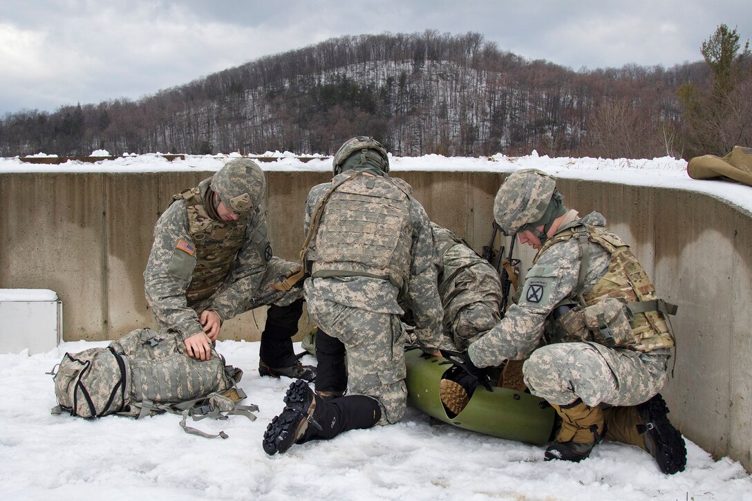 Army National Guard soldiers provide medical aid to a mock casualty during a live-fire exercise at Camp Ethan Allen Training Site, Jericho, Vt., Jan. 26, 2017. The soldiers are assigned to the Vermont, Maine and New Hampshire National Guard. Army National Guard photo by Spc. Avery Cunningham
