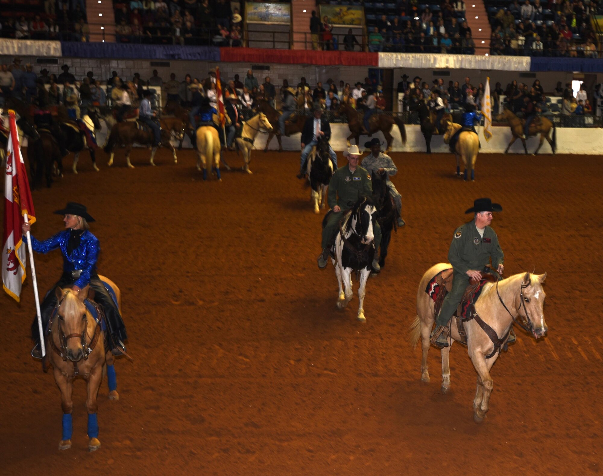 (Right corner to center) Col. Gregory Jones, 301st Fighter Wing commander, Col Stephen Seaman, 301 FW Director of Staff, and Chief Master Sgt. Terry Goines, 301 FW Command Chief, ride in the Grand Entry 30 January 2017, in Fort Worth, Texas, supporting Military Appreciation Day at the rodeo. For 121 years, the Stock Show has been a vital link to Fort Worth’s “Cowtown” heritage and, for over a decade, an annual venue to thank military stationed all over Texas. (U.S. Air Force photos by Ms. Julie Briden-Garcia)